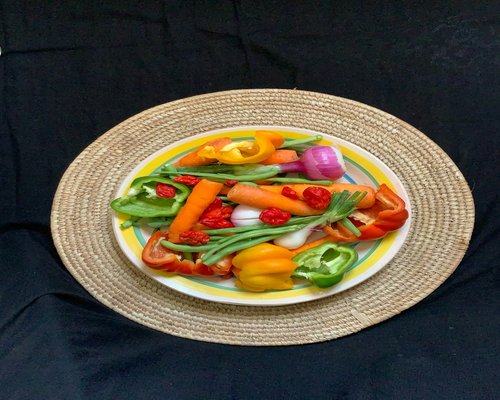 Fresh colorful vegetables and fruits on a plate for healthy diet